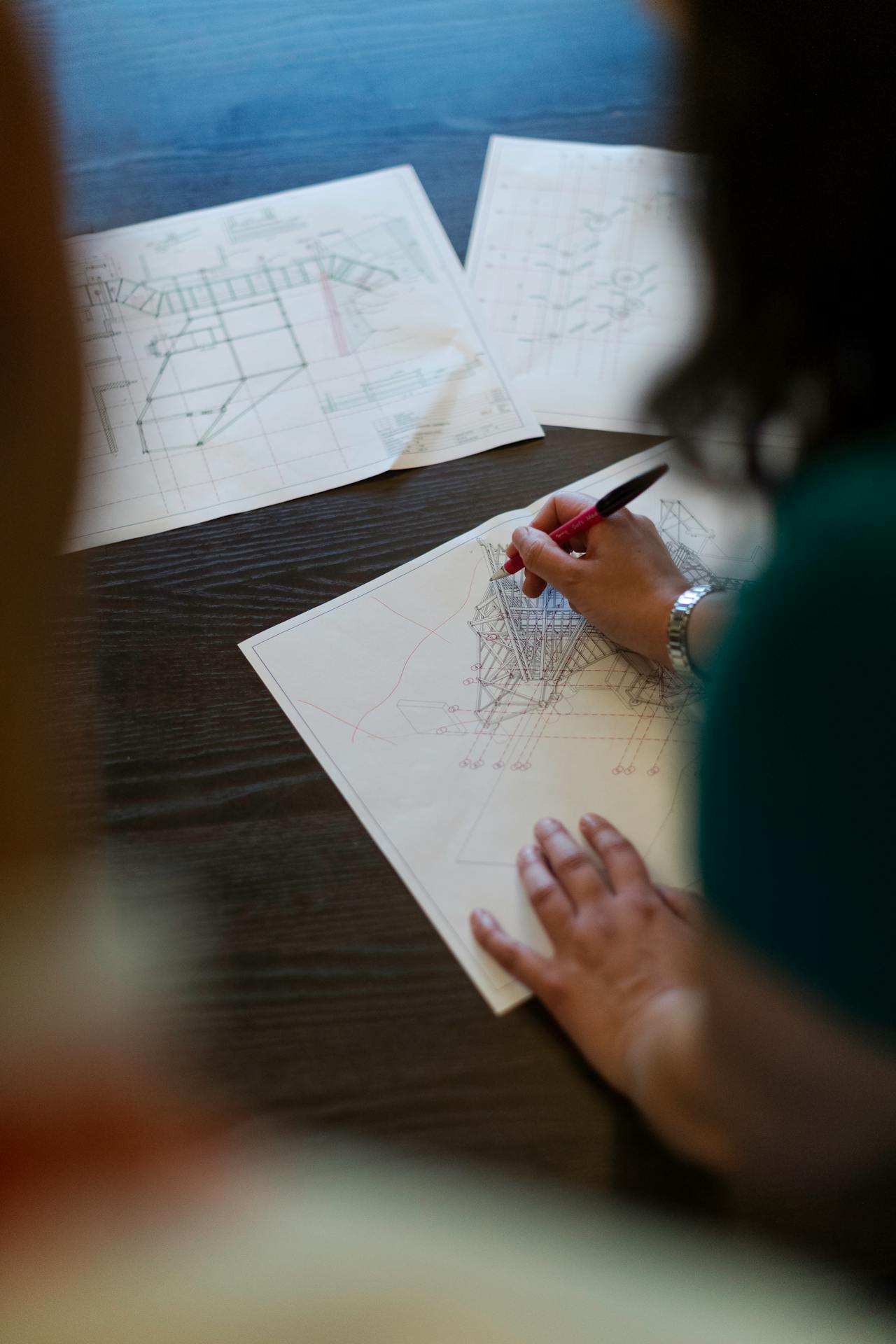 Close-up of a hand annotating construction plans