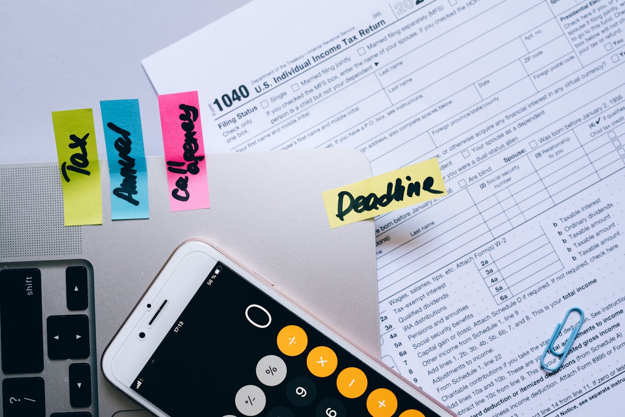 Quantity surveyor using a calculator on accounts